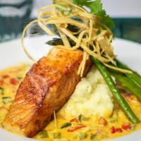 Crispy Skin Salmon · Pan-seared then placed on a bed of garlic mashed potatoes surrounded with a lobster chipotle...