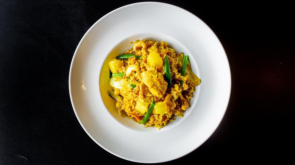 F-4. Pineapple Fried Rice · Stir-fried rice with egg, onions, scallions, pineapple, cashew nut, and yellow curry powder.