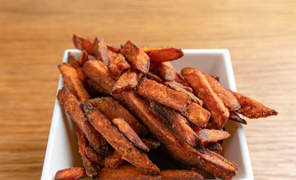 Sweet Potatoes Fries · Hand-cut organic sweet potatoes fries spiced with Cajun spices.