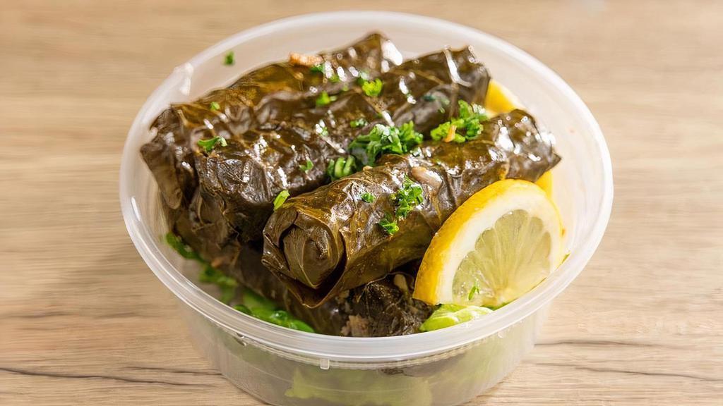 Grape Leaves · Hand rolled grape leaves stuffed with vegetable and rice.