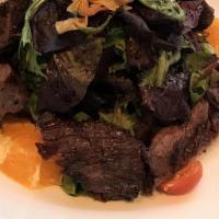 Asian Steak · Grilled hanger steak marinated with soy and ginger
sauce with Mixed greens and potatoes chips.