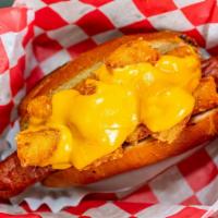 Tot Dog · Bacon wrapped hot dog with tater tots and melted cheese on top.