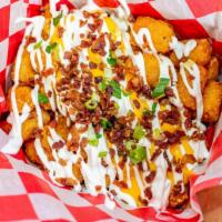 Baked N Loaded · Huntington Village favorite! Tots, sour cream, whiz and bacon.