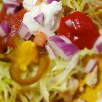 Nachos Lg · (Tortilla chips with melted cheese salsa, lettuce, tomatoes, sour cream and jalapeños, add c...