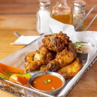 Chicken Wings · Delicious gluten-free buffalo wings served with a homemade dipping sauce, carrots, and celery.