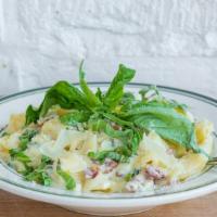 Pasta Carbonara · Rigatoni mixed with bacon and onion in a rich yolk cream sauce.