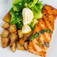 Grilled Salmon · With garlic and white wine sauce. Served with daily vegetables and roasted potatoes.