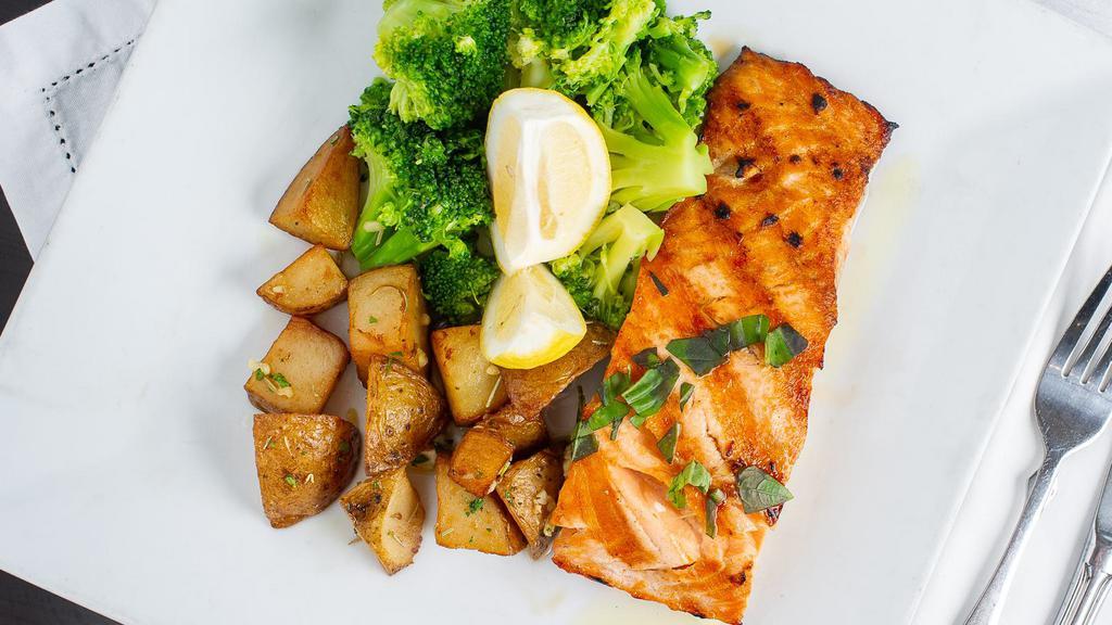 Grilled Salmon · With garlic and white wine sauce. Served with daily vegetables and roasted potatoes.
