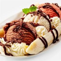 Banana Split · Three delicious scoops of ice cream and one banana decorated with chocolate syrup, strawberr...