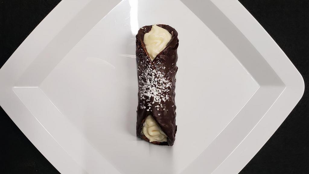Chocolate Covered Cannoli · A perfectly baked Cannoli Shell dipped in Chocolate and stuffed with our Homemade Ricotta Cheese or Custard.