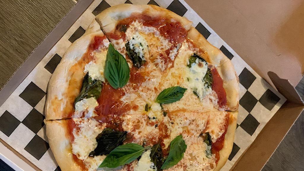 Margherita Pizza · Classic Neopolitan pizza. San Marzano tomatoes, fresh mozzarella & basil.