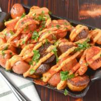 Patatas Bravas · Potatoes confit in spicy smoked paprika, oil, and aioli.