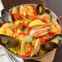 Seafood Paella · Traditional Spanish Paella: bomba rice with clams, mussels, shrimp, calamari, prawns, and ch...