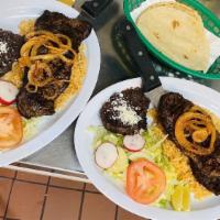 Grilled Steak · Steak Grilled with Sautéed Onions. Served with a salad, rice, beans & a tortilla.