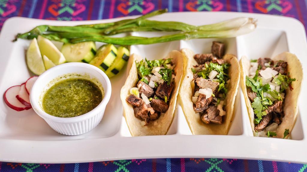 Tacos · Order of 3 White Corn Tortillas with your choice of Meat. Topped w/ Fresh Onions, Cilantro & Scallions.