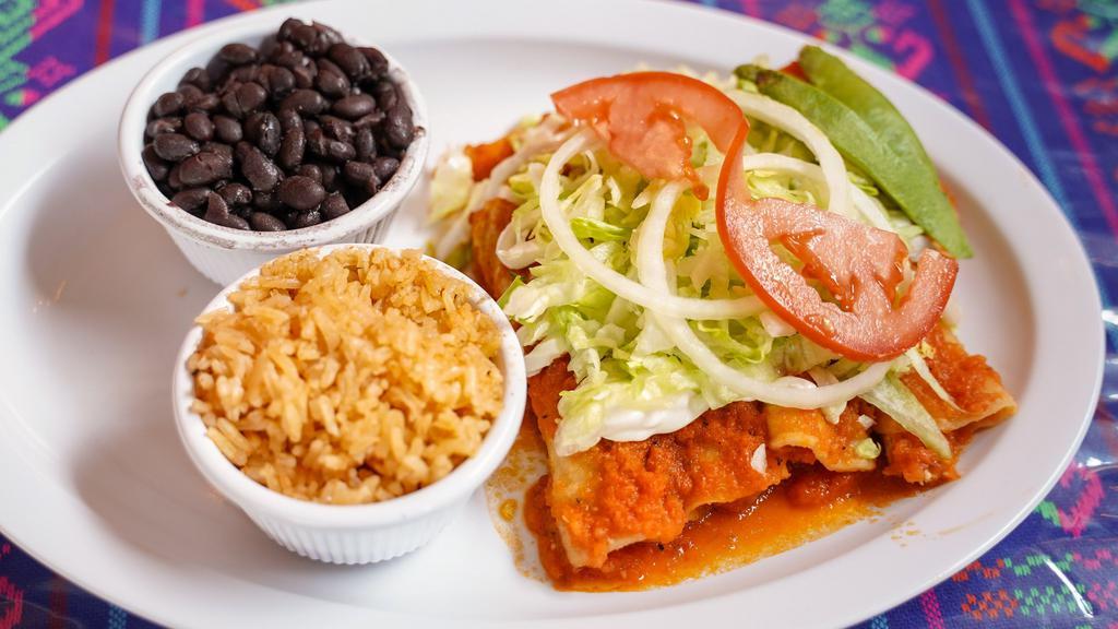 Enchiladas · Soft Folded Tortillas with your choice of Meat and Sauce. Topped with Sour Cream, Lettuce, Tomato, Onions, and a touch of Avocado. served w/ Rice & Beans.