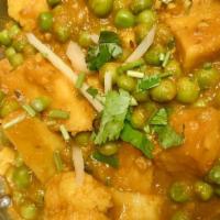 Aloo Matar Gobi · Florets of cauliflower, peas, and potatoes in delicate spices. Vegan.