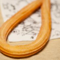 Churro · 9 to 10 inch-long loop shape churro serving with cinnamon sugar.