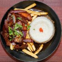 Peru Saltado · Onion and tomatoes sautéed. With signature spices, layered with french fries and served with...