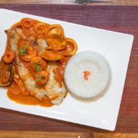 Pescado A Lo Macho · Fish in a traditional red sauce topped with shrimp served with our signature jasmine rice, r...