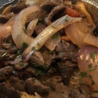 Lomo Saltado · Sirloin Steak Sautéed with Onions & Tomatoes Served Over French Fries with a Side of White R...