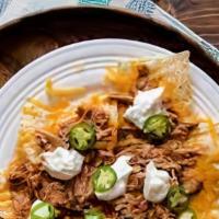 Nachos De Pollo · Chicken. Served with beans, cheese, sour cream and jalapenos.