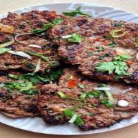Chapli Kabab · Ground chicken fried on a griddle.