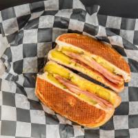 Cubano · Pork roll, swiss golden mustard, mayo and pickles pressed and grilled.