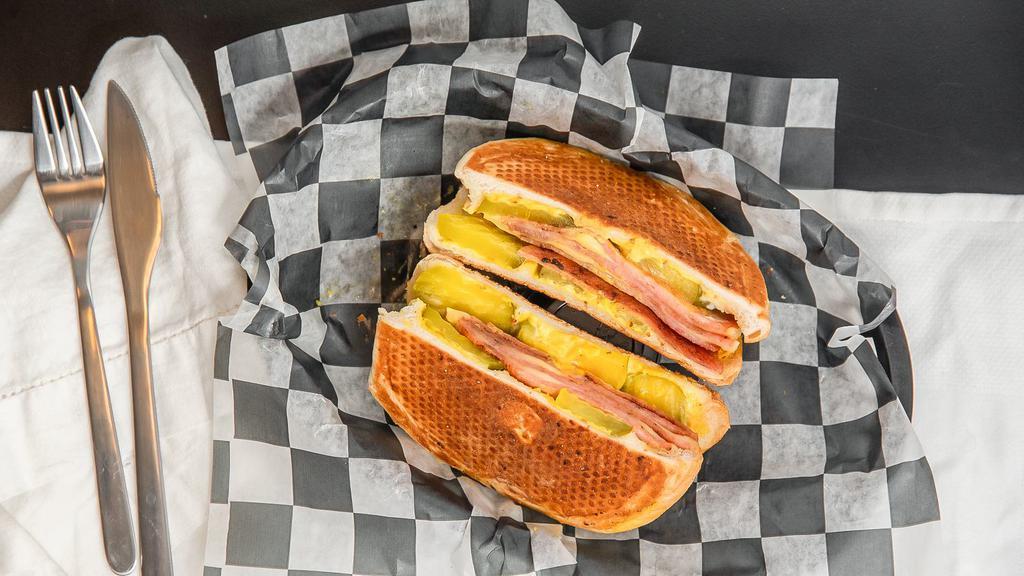Cubano · Pork roll, swiss golden mustard, mayo and pickles pressed and grilled.