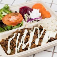 Flé-Flé Beef&Lamb Shawarma Bowl · Beef&Lamb Shawarma over rice topped with tahini sauce, a side of mix greens, cucumber pickle...