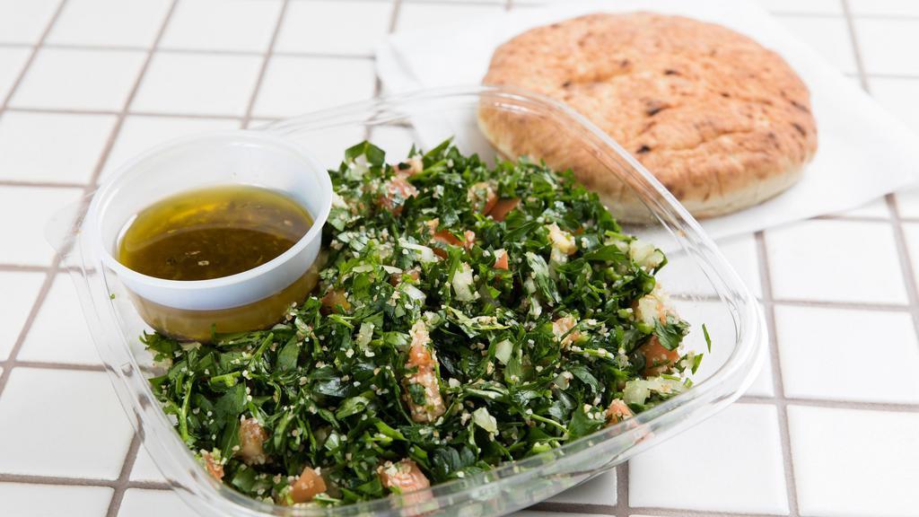 Tabbouleh Salad With Pita Bread · Vegetarian. Fresh parsley, wheat bulgur, fresh tomatoes, onions, fresh lemon juice and olive oil.