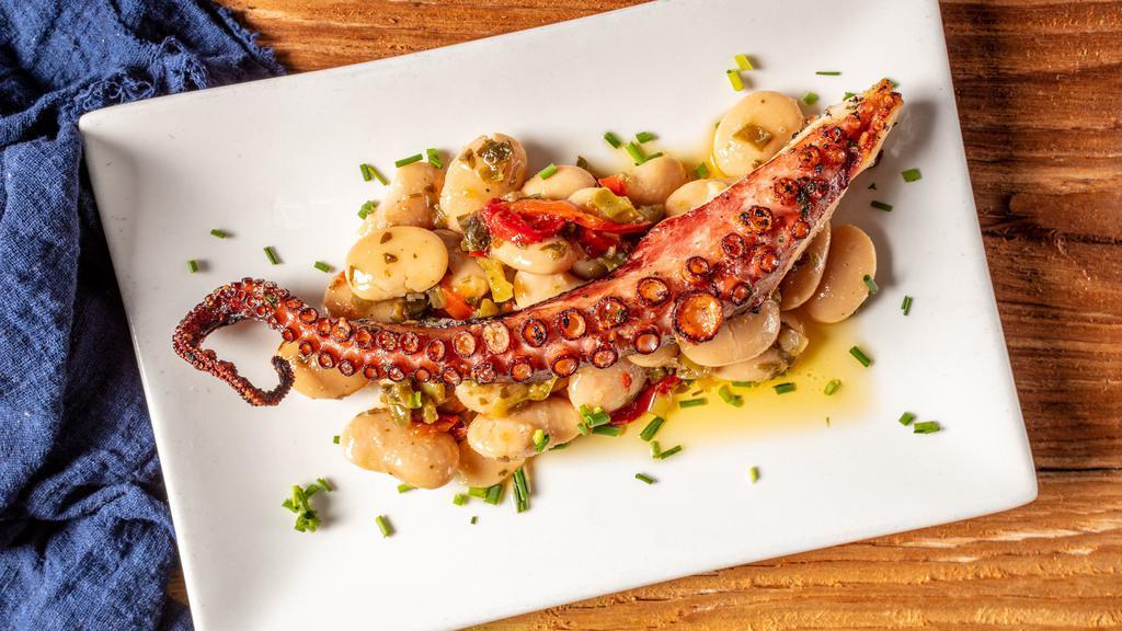 Grilled Octopus · Served over marinated gigante beans with fresh lemon, extra virgin olive oil, and herbs.