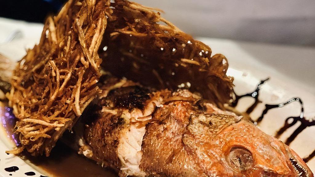 Whole Red Snapper · With fresh herb-citrus stuffing, balsamic glaze, boroccoli, and rice pilaf.