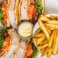 Turkey Club · Fresh roasted turkey, crisp bacon, tomato and leaf lettuce on toasted bread, served with fre...
