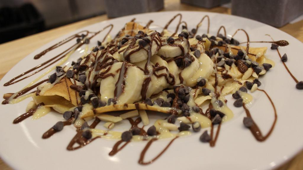 Magic Crepe · Banana, chocolate chip, nilla waffle crumb with condensed milk, Nutella and whip cream.