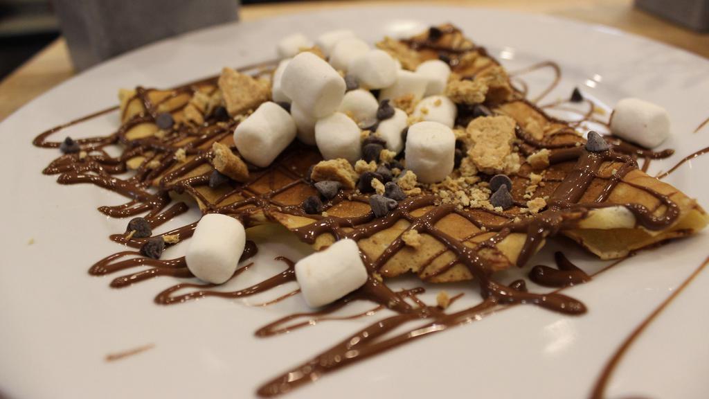 S'Mores Crepe · Marshmallow, chocolate chip, nilla waffle crumb with Nutella and whip cream.