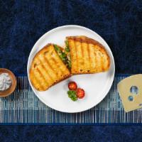 Cluck Chuck Parmesan Panini · Lemon grilled chicken, pesto sauce, roasted peppers, and fresh mozzarella on pressed Europea...