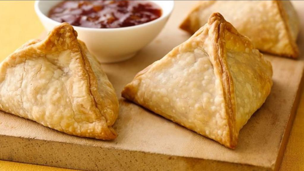 Samosas (2 Pc0 · Indian fried pastry with a savory filling such as spiced potatoes, onions, peas and lentils (2 pieces).