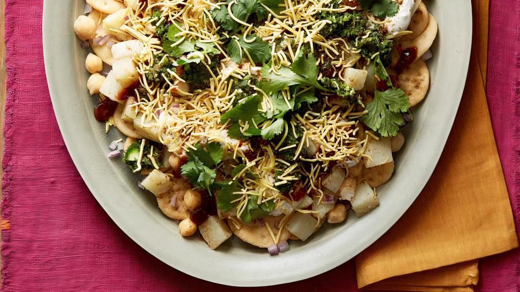 Aloo Papdi Chaat · Papdi chaat is traditionally prepared using crisp fried dough wafers known as papdi, along with boiled chick peas, boiled potatoes, yogurt and tamarind chutney and topped with chaat masala and sev.