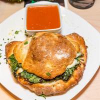 Calzone · Served with seasoned ricotta and mozzarella.