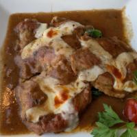 Veal Saltimbocca · Medallions of veal sautéed in a cherry wine sauce with prosciutto and melted mozzarella in a...
