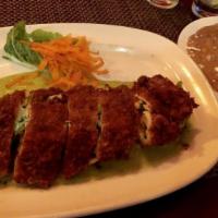 Pollo Relleno · Lightly fried breaded chicken breast stuffed with shredded carrots, zucchini, and Oaxaca che...