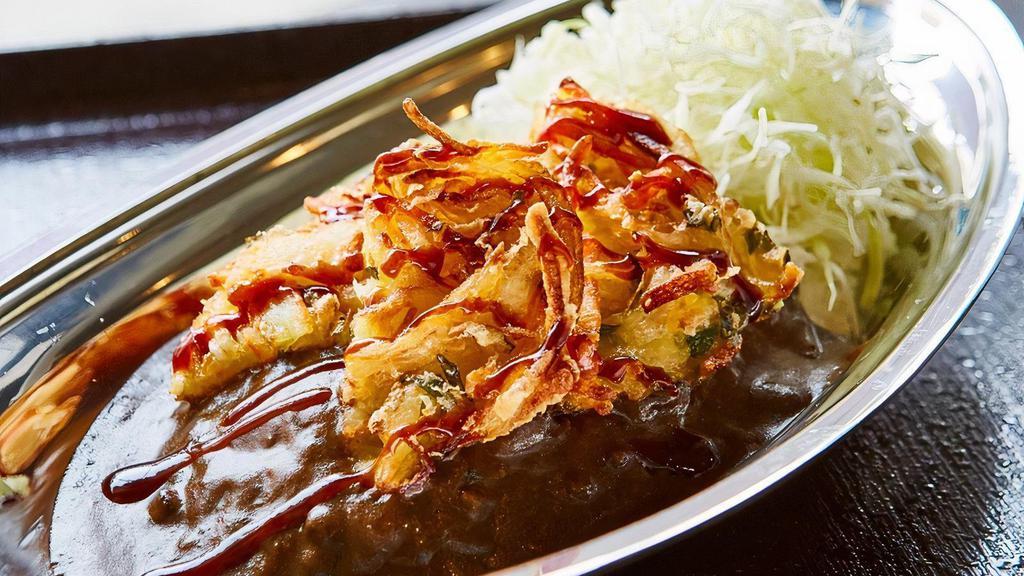 Veggie Tempura Curry · 2 Tempura-fried veggie patties, drizzled with tonkatsu sauce, served with shredded cabbage and Japanese homemade curry over rice. Curry sauce contains pork.