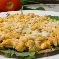 Arepa Con Huevos Pericos  · Corn, multigrain or quinoa arepa with scrambled eggs and hogao.