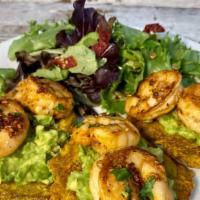 Camarones Al Ajillo · 6 jumbo shrimp over patacones (green plantains) with avocado served with palenque salad.