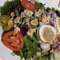 Warm Goat Cheese · Mixed greens, tomato, red onion and olives with warmed bread crumb crusted goat cheese medal...