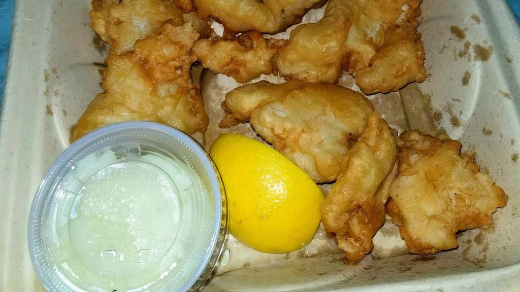 Boukes Bakaliarou · Codfish dipped in batter and pan-fried to golden brown and served with a touch of garlic dip.