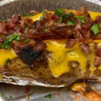 Loaded Baked Potato · Giant baked potato loaded with cheese and bacon.  Served with a side of sour cream.