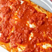 Upside Down Pie · Square pie with fresh mozzarella under San Marzano tomatoes.