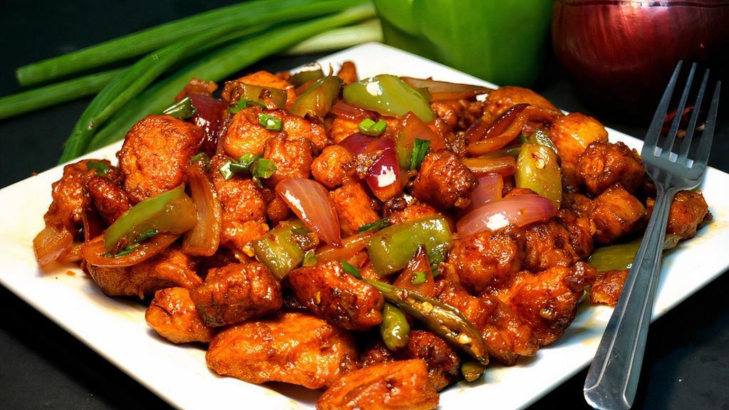 Chili Chicken · Fried boneless chicken sauteed in spicy chili sauce with onion and bell pepper.